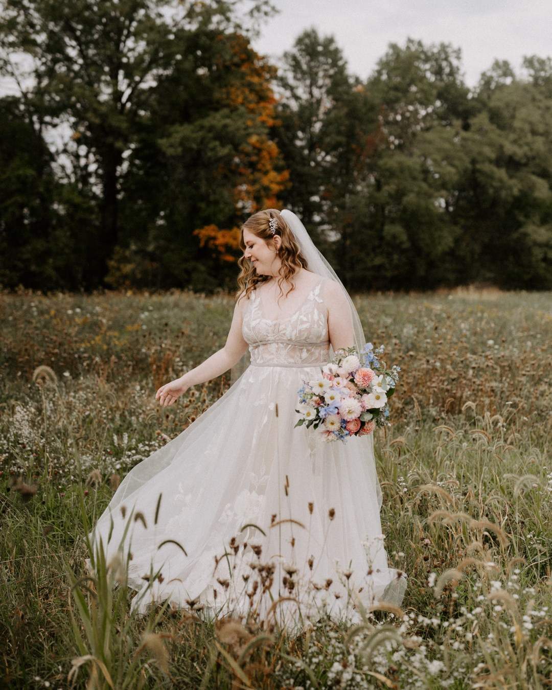 Bride twirling in a flower field at Jorgensen Farms in Columbus, Ohio. Natural lighting, soft romantic tones. Photo by Ashley Wallace Photography.
