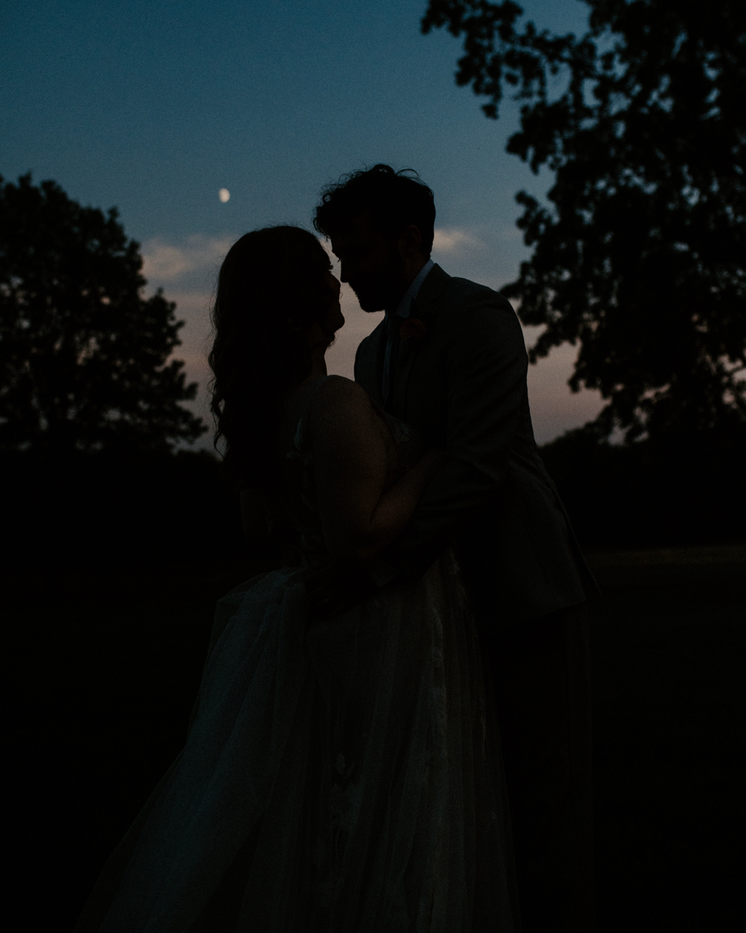 Romantic moonlit moment between bride and groom at Jorgensen Farms in Westerville, Ohio, captured by Ashley Wallace Photography. Intimate wedding portrait under the stars in a magical outdoor setting.