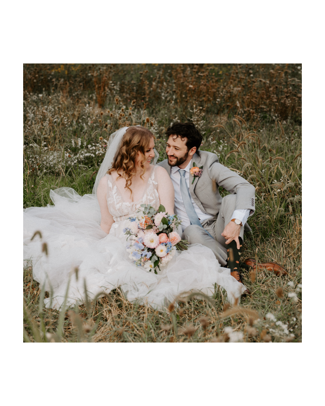 Bride and groom sitting in a flower field on a perfect fall day at Jorgensen Farms in Westerville, Ohio, captured by Ashley Wallace Photography. Romantic outdoor wedding portrait in a vibrant, autumn setting.